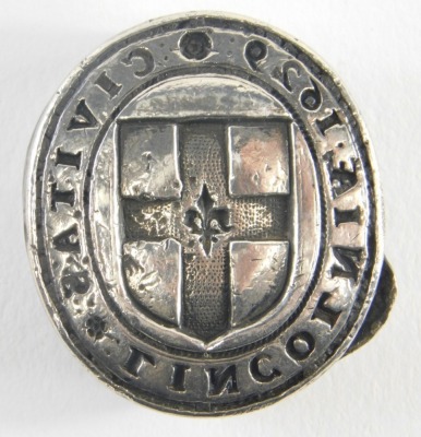 A 17thC Lincoln lead seal, of oval form, centred with shield and marked CIAITAS TIMCOTMIVE, dated 1650 on the reverse seal, silvered, 4cm x 3cm.