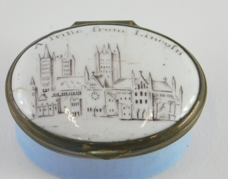 A Trifle from Lincoln enamel patch box, of oval form, with mirror to the lid, with Lincoln Cathedral to the exterior, 3cm high.