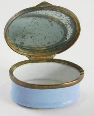 A Trifle from Lincoln enamel patch box, of oval form, with mirror to the lid, with Lincoln Cathedral to the exterior, 3cm high. - 2