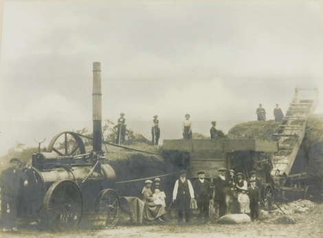 An early 20thC photograph, of a Lincolnshire field with a Caterpillar tractor, possibly Rustons, and farm hands, 15cm x 20cm, and another photographic print of figures hay making in a Lincolnshire field. (2)