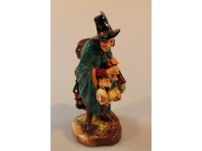 A Royal Doulton figure The Mask Seller no. HN2103