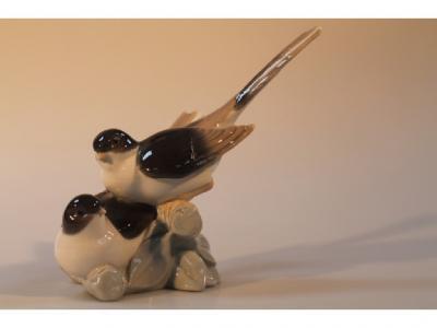 A Lladro figure group of two birds on a branch