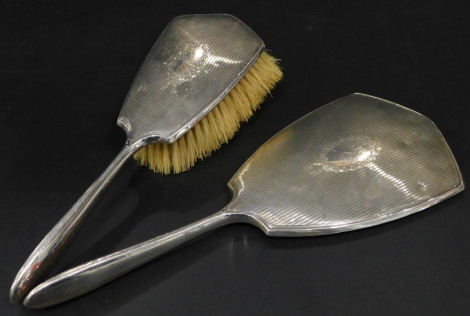 A silver mounted mirror and hand brush