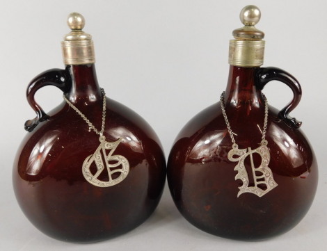 A pair of Victorian brown tinted mallet shaped claret jugs