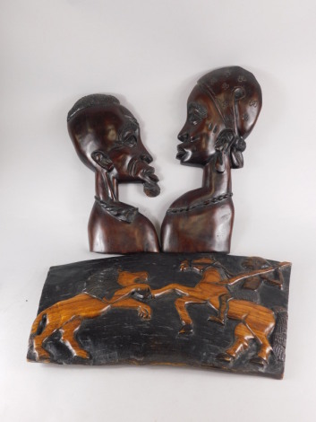 Tribal art. A pair of African style hardwood wall mounted busts