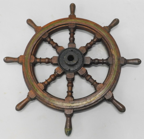 A hardwood and brass ship's wheel