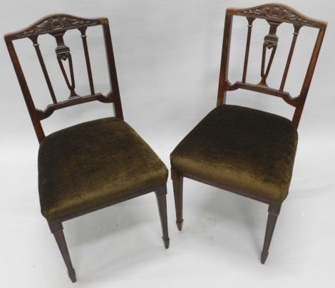 A pair of Edwardian mahogany salon chairs