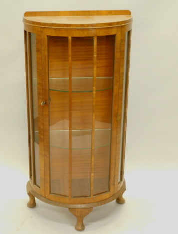 A 20thC walnut bow fronted display cabinet