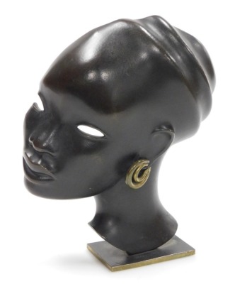 Karl Hagenauer (1898-1956). A bronze bust of an African lady, with gold coloured double hoop earring, on a gilt bronze rectangular base, stamped Hagenauer Wien, monogrammed, hand made, Made in Vienna, Austria, 22cm high.