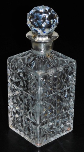 An Elizabeth II cut glass and silver mounted decanter, Sterling Silverware Ltd, Sheffield 1972, 26cm high.