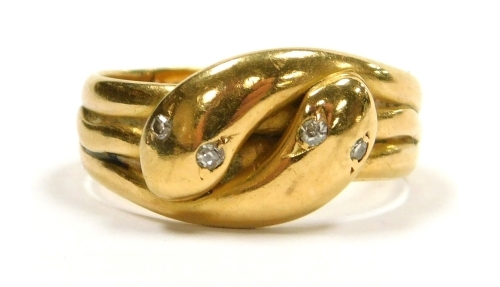 An 18ct gold ring of double serpent form, each serpent's head inset with diamond eyes, approximately 0.08ct, size P/Q, 6.2g.