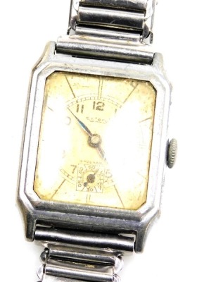 A mid century Rotary gentleman's stainless steel cased tank wristwatch, the canted rectangular yellow metal dial bearing Arabic numerals, subsidiary seconds dial, case back numbered 254765, on a bracelet strap, boxed.