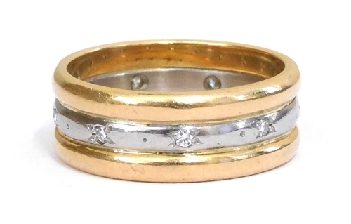 A diamond set triple wedding band, grain set in white and yellow metal, stamped platinum, size K/L, 6.7g.