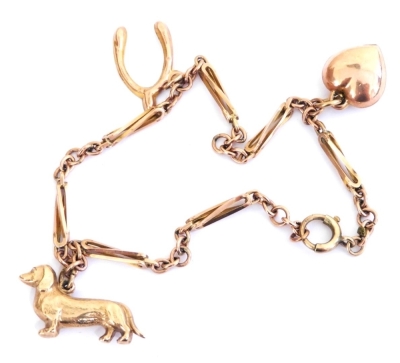 A 9ct gold charm bracelet, with three charms, as fitted, on a bolt ring clasp, 4.9g.