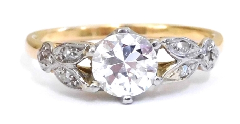 A diamond solitaire ring, with diamond set floral and foliate shoulders, in yellow metal, central diamond approx 0.78ct, size O, 2.7g.