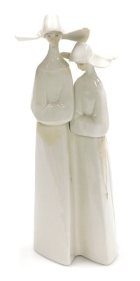 A Lladro porcelain figure group of two nuns, printed and impressed marks, 33cm high, (AF).