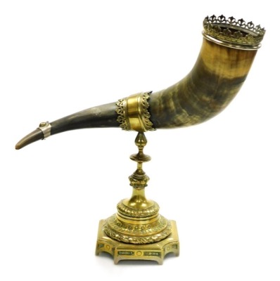 A 19thC cattle horn centrepiece, with a pierced brass crown mount, on a brass stand, 38cm high, 33cm wide.