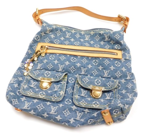 A Louis Vuitton Baggy GM monogram denim shoulder bag, with cow hide leather strap and zip opening, the front with two pouches, with brass lock plate closures, a multi charm keyring, the central zip enclosing a suede interior, 32cm high, 34cm wide, bag dro