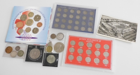 A group of pre decimal coinage, to include Queen Elizabeth II sixpences from 1953-1967, George V threepences from 1917-1936, commemorative crown, brilliant uncirculated coin collection for 2000, etc.