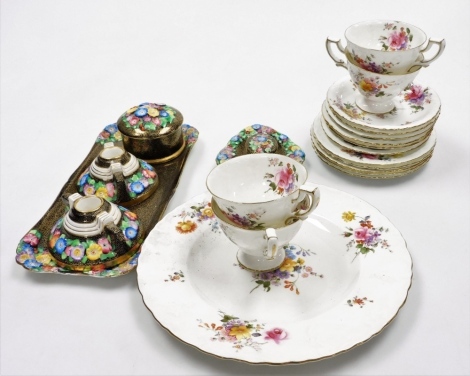 A Royal Crown Derby part tea service, decorated in the Vine pattern, comprising four teacups, six saucers, five side plates and a cake plate, and a group of Tuscan china porcelain decorated with moulded flowers against a black and gilt floral sheet patter