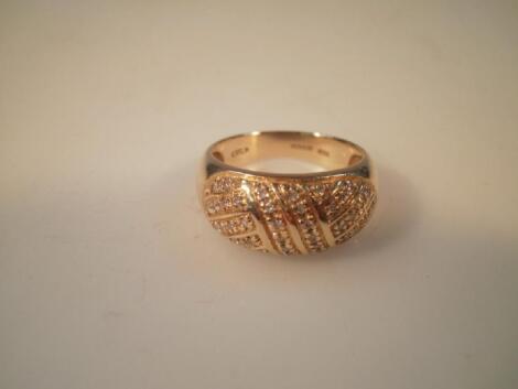 A bombe shaped dress ring set in 18ct gold