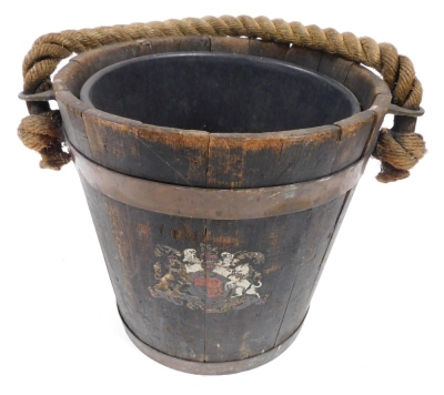 A Victorian wooden fire bucket, with a rope handle, copper banding and painted royal coat of arms, 30cm high excluding handle.