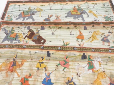 Three Indian hand painted silk work pictures, depicting hunting scenes on elephants and horseback, each 37cm x 102cm.