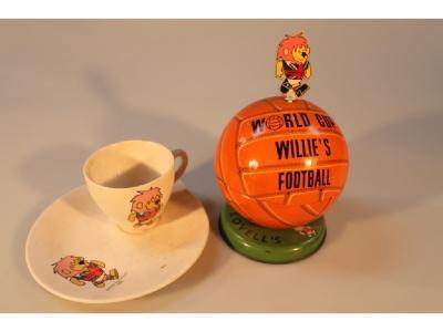 A 1966 World Cup Lovell's commemorative football shaped tin and a World