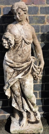 A composition garden statue, of a scantily clad lady, in classical dress holding a bunch of grapes, on a square base, 120cm high.