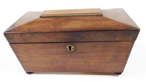 A Regency mahogany sarcophagus shaped tea caddy, the hinged lid enclosing two separate lidded divisions, on bun feet, 29cm wide. (AF)