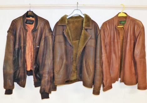 A brown leather flying type jacket, and two other leather jackets, labels for Top Grade Hyde Park. (3)