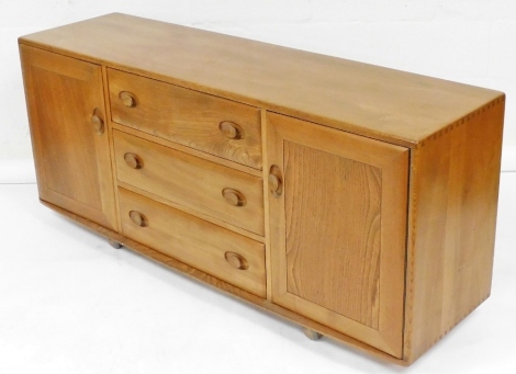 An Ercol light elm sideboard, the three central drawers flanked by two cupboards, 68cm high, 153cm wide, 43cm deep.