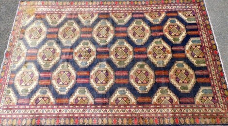 A Causasian rug, decorated with rows of full hand half guls against a blue gound, 260cm x 170cm.