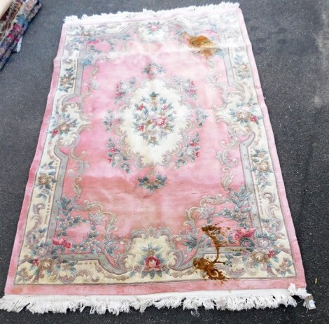 A Chinese wool pink ground rug, floral decorated in the Aubusson style, 300cm x 185cm.