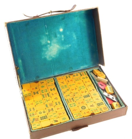 A Mahjong set, in leather case with resin pieces, the case 28cm wide.