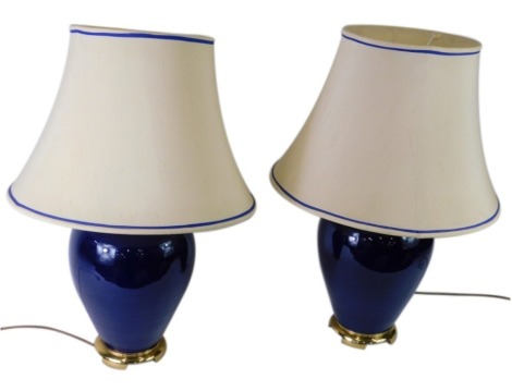 A pair of blue glazed and glass ceramic table lamps with shades, 71cm high.