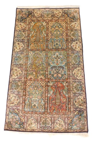 A Persian silk rug, with a design of flowers, leaves, etc., within compartments, 163cm x 94cm.