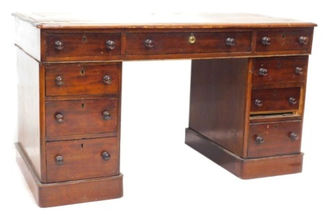 A Victorian mahogany pedestal desk, the rectangular top with a brown leather inset above an arrangement of nine drawers, on a plinth, 67cm high, 119cm wide.