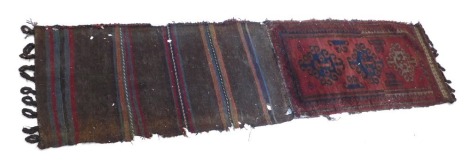 A Turkoman camel bag or Juval, with a design of three medallions on a red ground with one wide border, 210cm x 56cm.