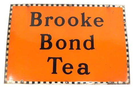 A Brooke Bond Tea enamel advertising sign, on orange ground with chequered border, 51cm x 76cm.