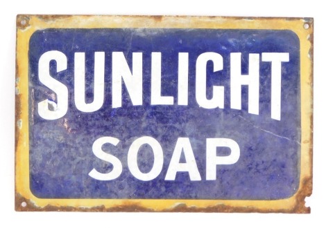 A Sunlight Soap advertising enamel advertising sign, with a yellow border on blue and white central panel, 20cm x 30.5cm. (AF)