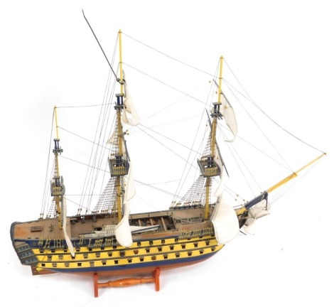 A wooden model of a galleon, over three tiers, with three masts, on turned base, 80cm high, 85cm wide, 23cm deep.
