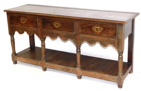 An oak dresser in 18thC style, with arrangement of three drawers with fret gallery base, on bun feet, 74cm high, 158cm wide, 52cm deep.