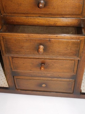 An oak dresser, with arrangement of two cupboard doors and two drawers, and central four drawer section, one handle lacking, 91cm high, 152cm wide, 52cm deep. - 3