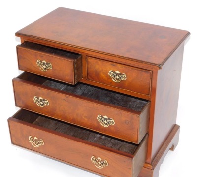 A walnut chest of drawers, two short and two long drawers, with brass handles on bracket feet, 60cm high, 66cm wide, 35cm deep. - 2