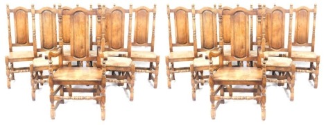 A set of fourteen oak dining chairs, each with an oval back on bobbin turned supports, comprising two carvers.