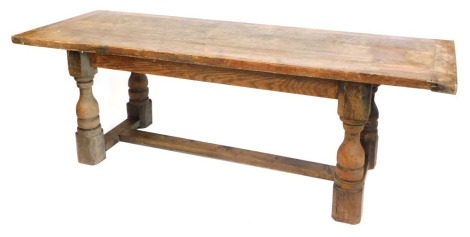 An oak refectory table, with planked top on H frame base, 76cm high, 231cm wide, 74cm deep.