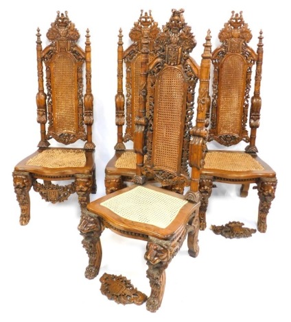 A set of four hardwood carved Carolean style highback chairs, each with a moulded crest and cane rush seat, on out scrolled legs, 156cm high. (AF)