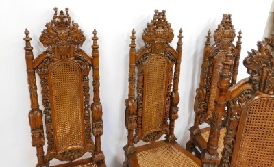 A set of four hardwood carved Carolean style highback chairs, each with a moulded crest and cane rush seat, on out scrolled legs, 156cm high. (AF) - 2