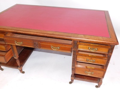 A Maple & Co of London walnut writing desk, with red leather inset top above arrangement of two pedestals each with three drawers and shelf and two central drawers with brass swing handles, carved and turned supports, 77cm high, 153cm wide, 89cm deep. - 2